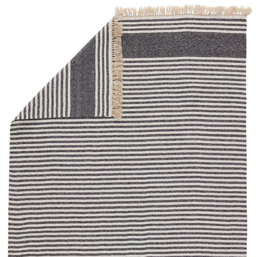 The Jaipur Living Morro Bay Strand Area Rug, or MRB01, is a chic, coastal-inspired dhurrie designs. The ticking stripe Strand rug complements both indoor and outdoor spaces with a colorway of dark gray and beige. Handwoven of durable polypropylene, this low-profile rug is easy to clean and perfect for high-traffic areas.