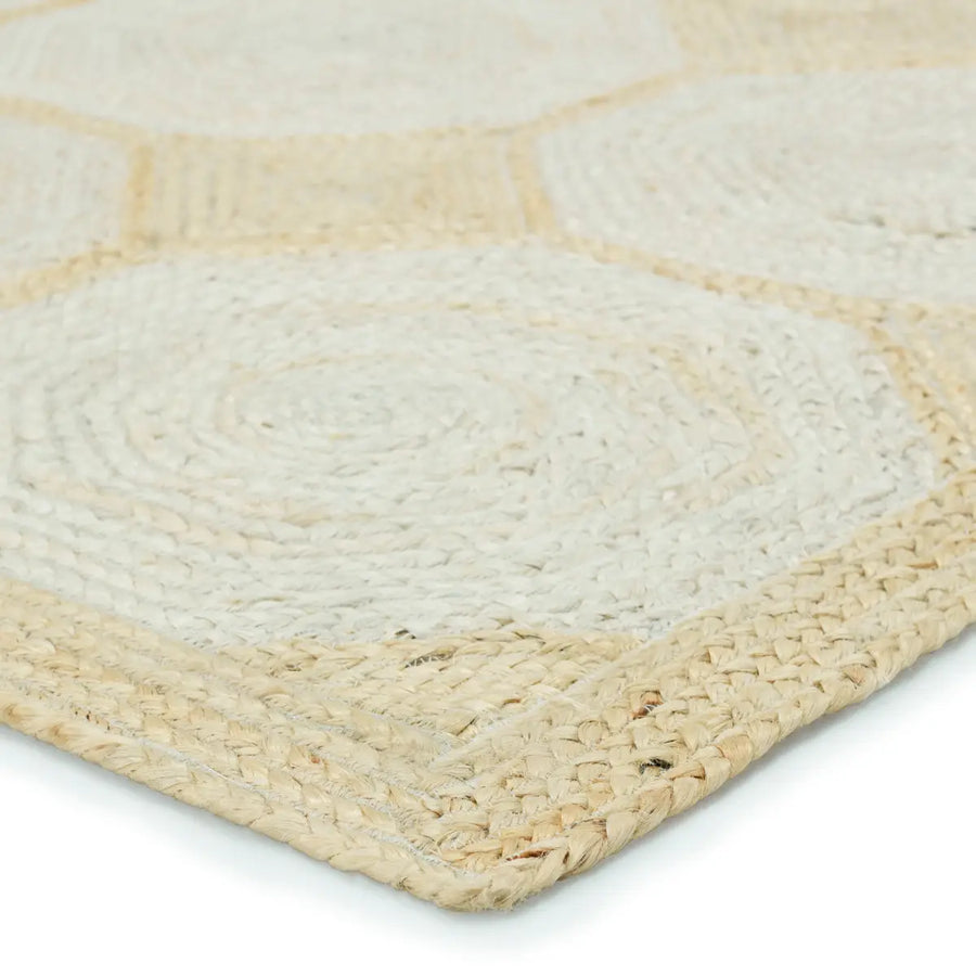 The Naturals Tobago Fiorita Area Rug by Jaipur Living provides a staple to transitional homes with a neutral colorway and organic style. A rectangular border frames the intricately woven, bleached octagonal design for a modern coastal look.