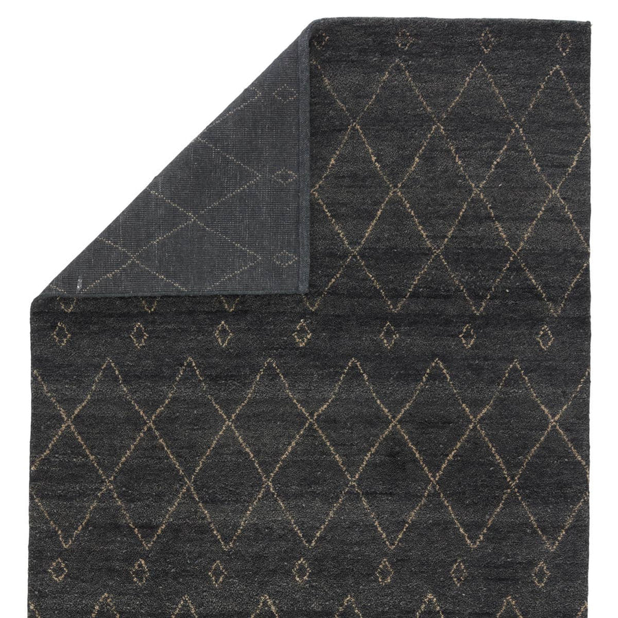 Inspired by simple nomadic designs, this hand-knotted Jaipur Living Nostalgia Casablanca Area Rug, or NS03, offers a sleek Moroccan motif to modern homes. A zigzag lattice pattern lends interest to this ultra-plush wool layer, while a deep gray and white colorway provides a rich and versatile look to any space.