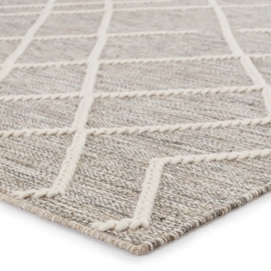 This Plateau Moab Fallen Rock / Whisper White Area Rug by Jaipur Living is crafted of jute, wool, and cotton. This showcases an ingenious braid weave technique that breathes life into the simple natural fiber foundation. The broken trellis motif lends geometric interest to the neutral gray and ivory colorway. PLT02