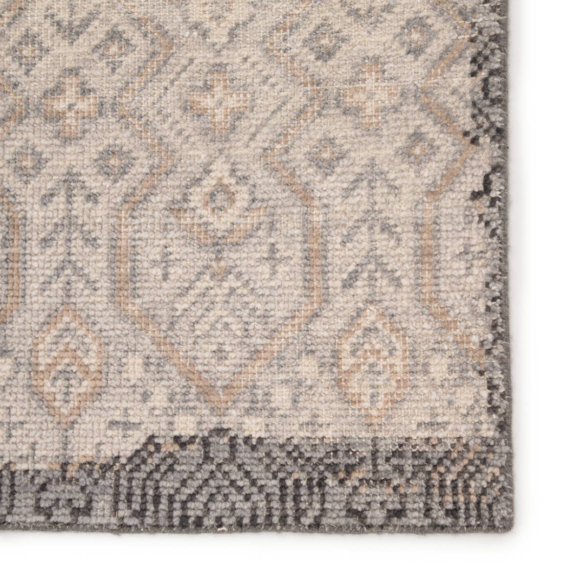 The Revolution collection is inspired by traditional style and beautifully detailed antique textile designs. The hand-knotted Prospect area rug showcases a captivating geometric design in muted tones of gray and gold. A charcoal edge creates a unique border effect around this globally inspired wool rug.  Hand-Knotted 100% Wool REL10