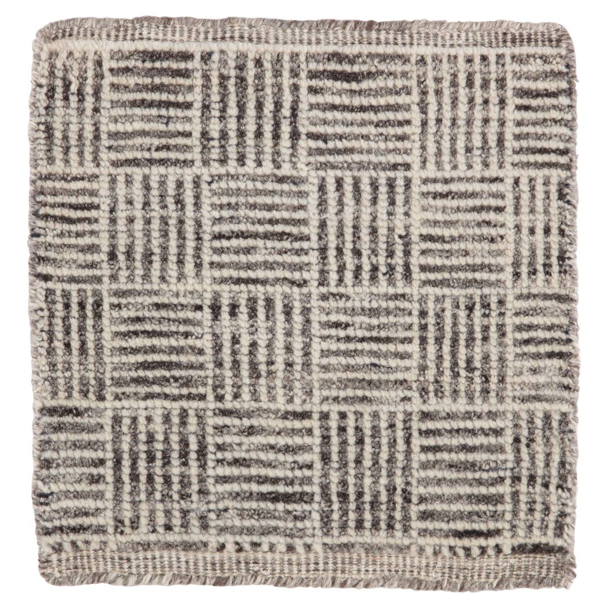 The Rize Mugler Area Rug offers intricate and delicately designed global patterns to the modern home. A thatched square motif creates an eye-catching geometric design on the artistically distressed Mugler area rug. In an earthy ivory and black colorway, this durable hand-knotted wool accent blends a timeless craft with contemporary charm.  Hand Knotted 100% Wool RIZ05