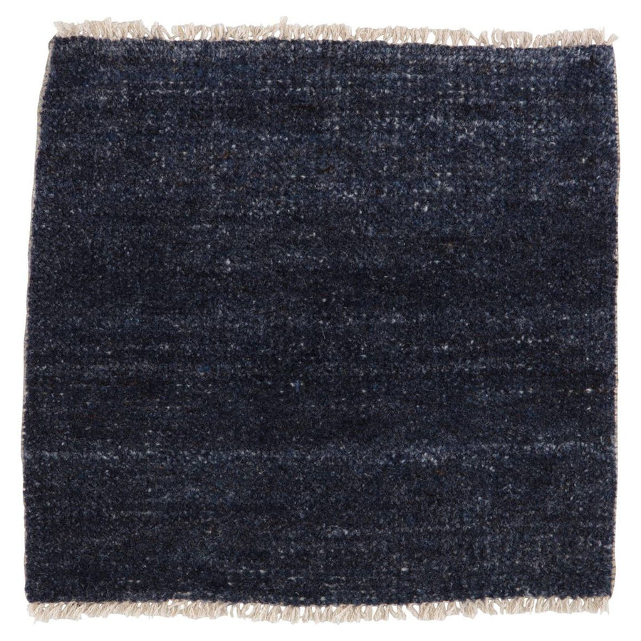 The Saga Origin Area Rug - Dark Denim by Jaipur Living, or SAG01, anchors a space with a solid, subtly striated design in a rich blue colorway. Hand knotted by skilled artisans, this durable wool accent marries simplicity and luxury with an exceptional quality.