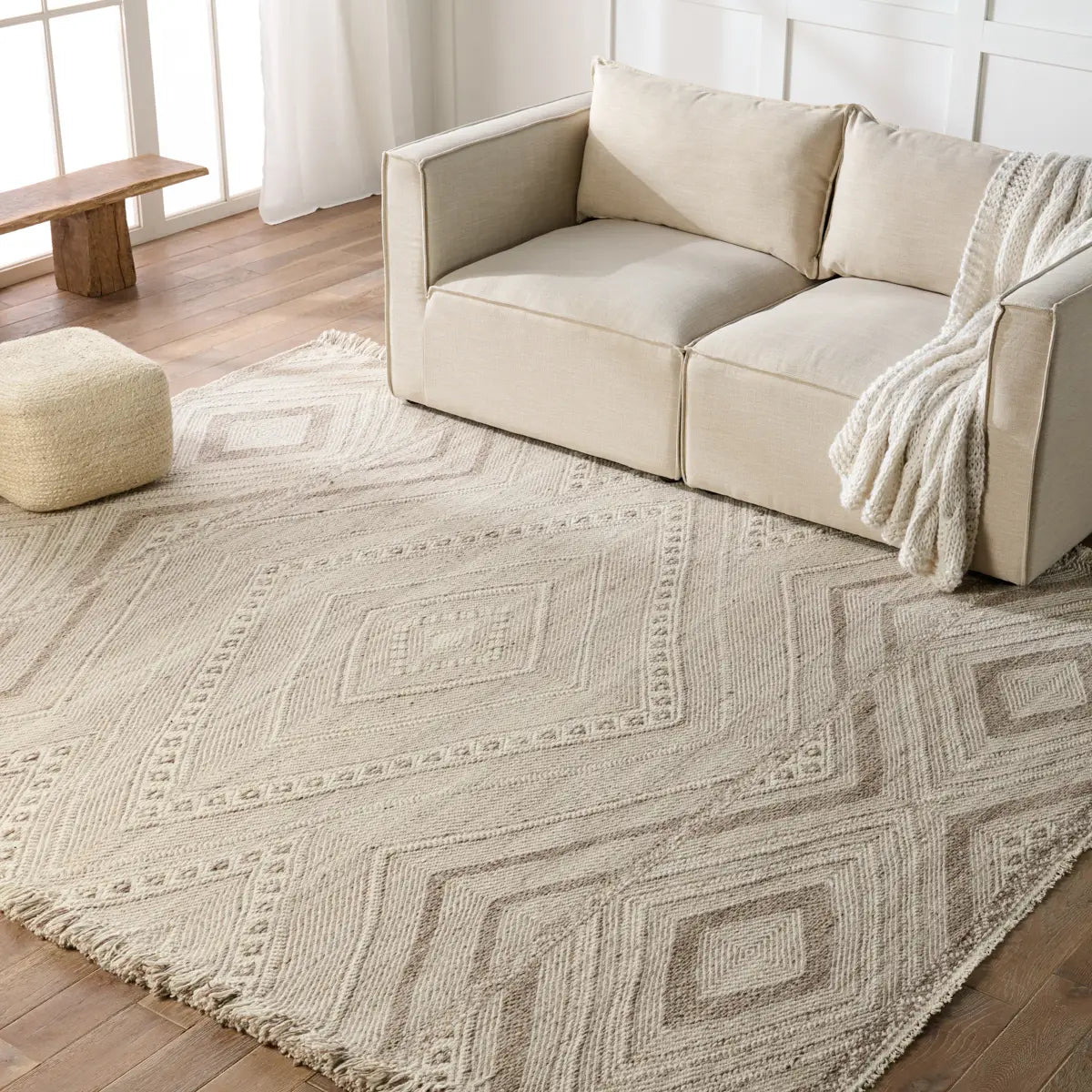 The handwoven Satori Suriya Area Rug by Jaipur Living features a versatile, neutral palette and an intricate tribal and diamond pattern. The short fringe detail adds texture to this light brown and cream-colored piece. This Moroccan style area rug fits perfectly in high traffic areas. 