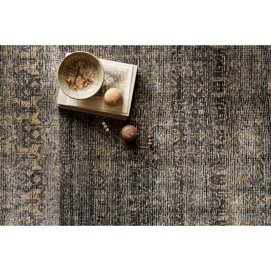 Hand-knotted in India of 100% wool, the Amara Collection creates a casual yet refined vibe with high-end appeal. With hints of yellow and pink woven into the charcoal base, this is a gorgeous rug to showcase in your living room, entryway, bedroom, or other high traffic area.   Hand Knotted 100% Wool AMM-03 Charcoal/Lagoon