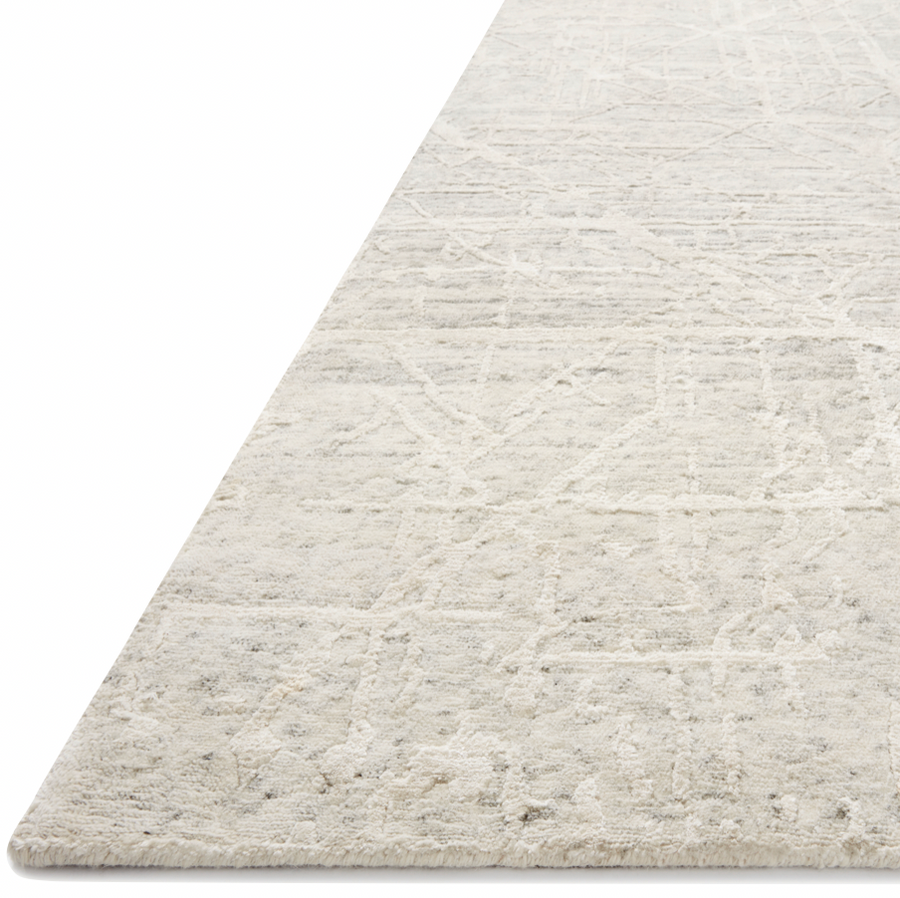 The Atlas Bone / Silver Area Rug by Loloi, or ATL-03, showcases striking contemporary patterns with a sophisticated color palette. Bold yet approachable, Atlas' muted linear designs create a sense of refined movement. Hand Knotted. Wool | Nylon