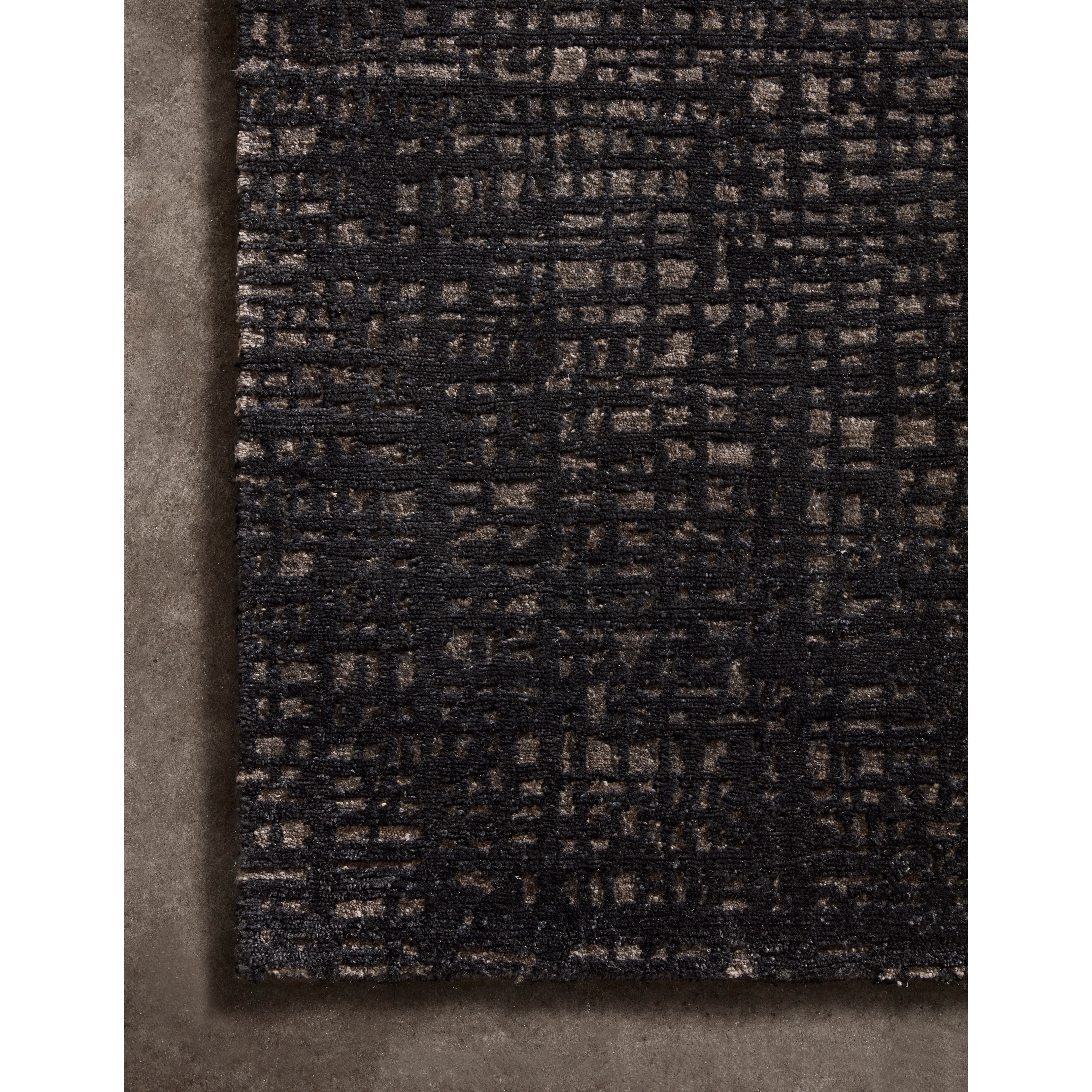 The Atlas Black / Bark Area Rug by Loloi, or ATL-05, showcases striking contemporary patterns with a sophisticated color palette. Bold yet approachable, Atlas' muted linear designs create a sense of refined movement. Hand Knotted. Wool | Nylon