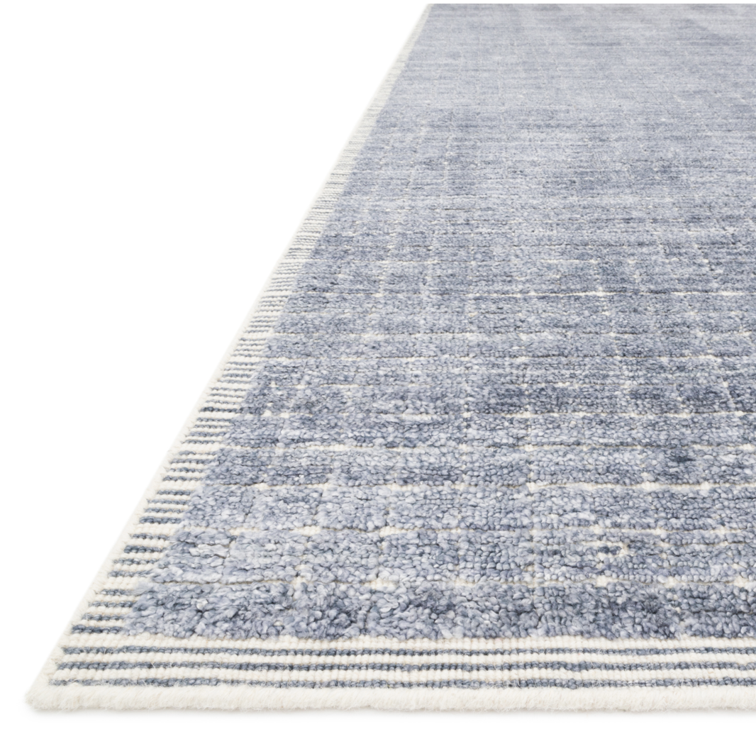 Modern and refined, the Beverly Denim rug by Loloi is hand-loomed by master artisans of viscose and wool pile. Clean lines and minimalist hues allow you to layer Beverly into any room.  Hand Loomed 68% Viscose | 32% Wool BEV-01 Denim