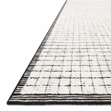 Modern and refined, the Beverly Ivory/Black rug from Loloi is hand-loomed by master artisans of viscose and wool pile. Clean lines and minimalist hues allow you to layer Beverly into any room.  Hand Loomed 69% Viscose | 31% Wool BEV-01 Ivory / Black