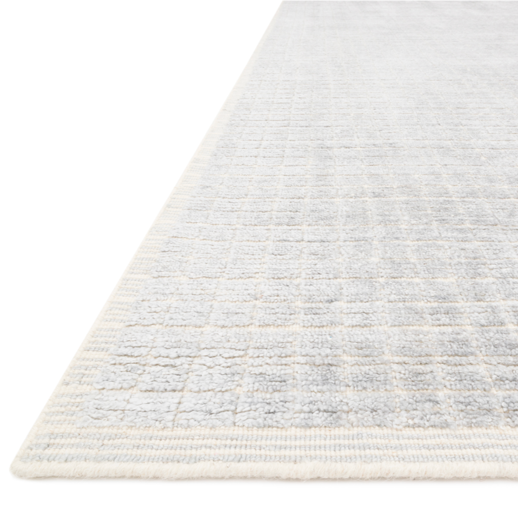 Modern and refined, the Beverly Silver/Sky rug from Loloi is hand-loomed by master artisans of viscose and wool pile. Clean lines and minimalist hues allow you to layer Beverly into any room.  Hand Loomed 68% Viscose | 32% Wool BEV-01 Silver / Sky