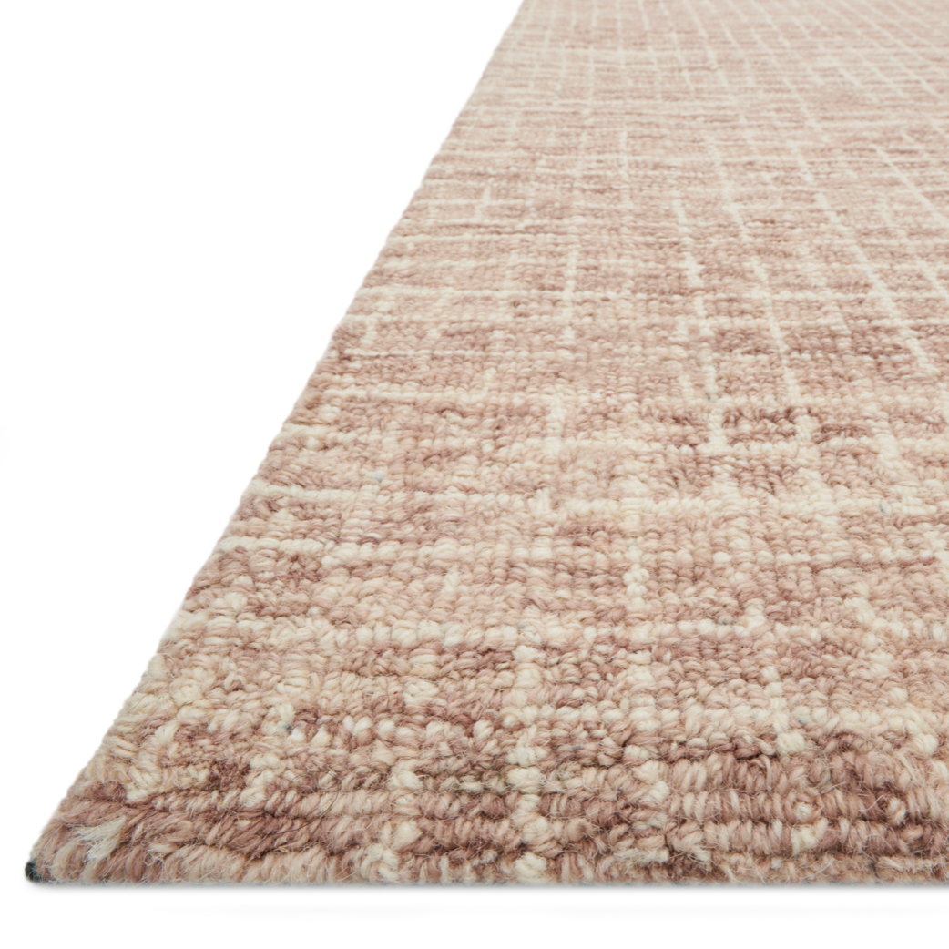 Inspired by textural watercolors, the Giana Blush Area Rug combines a relaxed grid with soft variations of cream and blush for an effortless and sophisticated look. Each area rug is hooked of 100% wool by artisans for a beautiful textural layer to your home. The soft textures of this area rug bring warmth and coziness to any room.  Hooked 100% Wool GH-01 Blush
