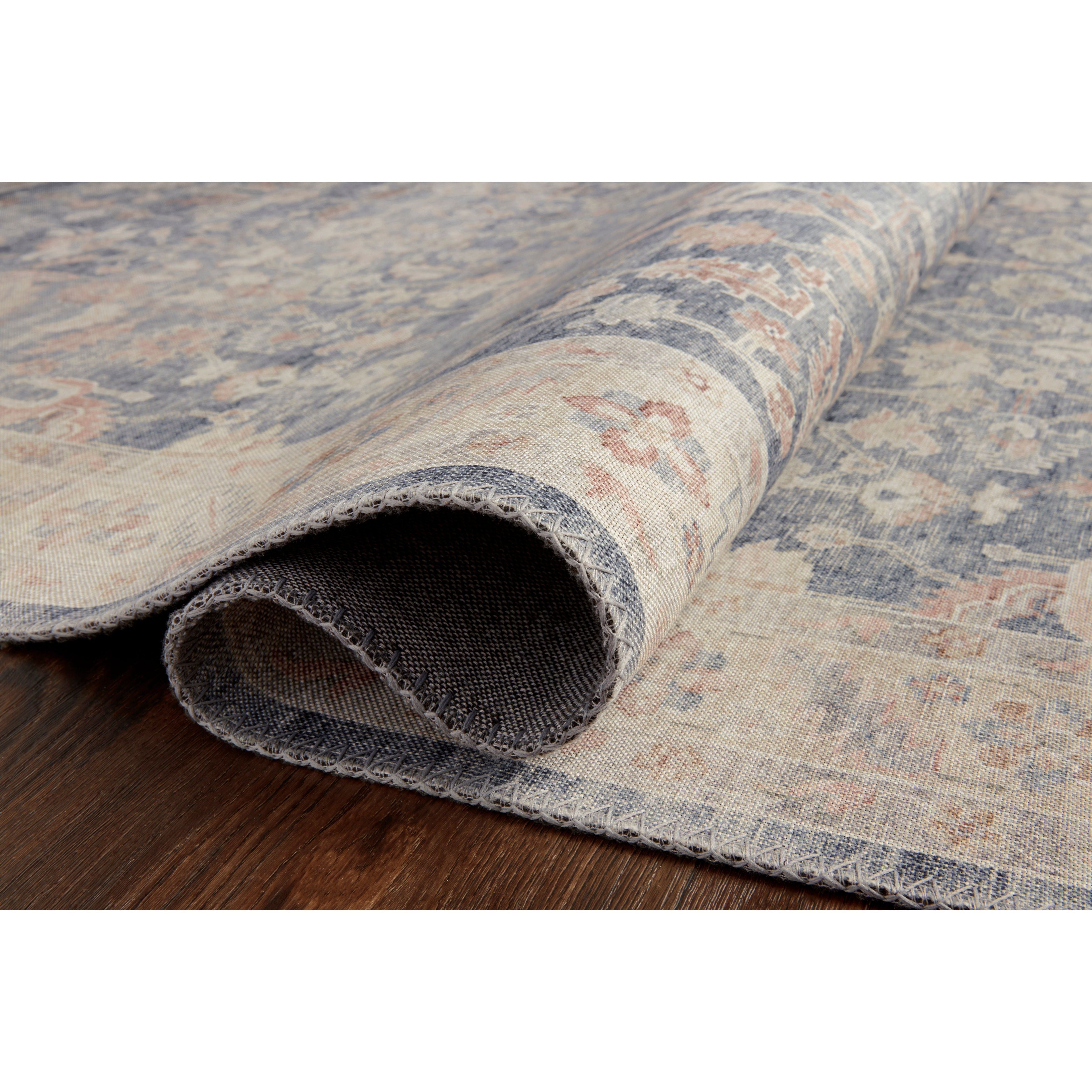 Featuring soft motifs in a carefully curated color palate of blue, yellow, red, and hints of orange, the Hathaway Denim / Multi area rug captures the essence of one-of-a-kind vintage or antique area rug at an attractive price.