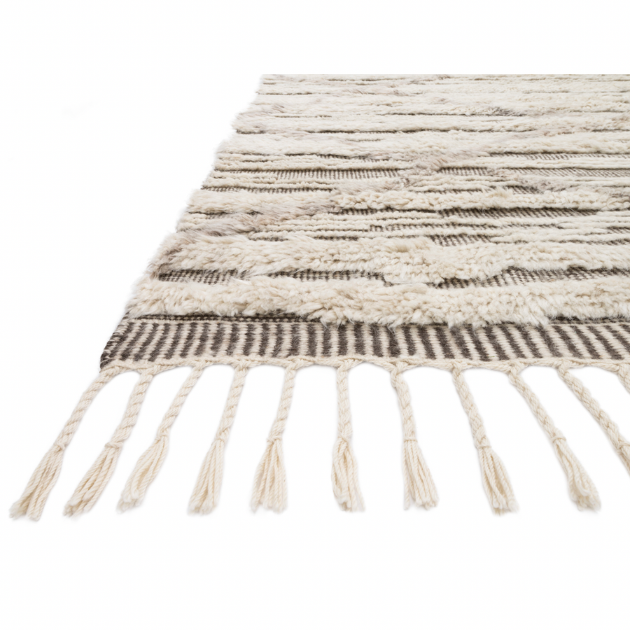 A nod to timeless Moroccan style, the Khalid Collection is hand-knotted in India by skilled artisans. The soft pile features 100% natural, undyed wool, lending slight variations in tones that make each piece it's own. Plus, each rug is finished with a thoughtfully designed fringe.  Hand-Knotted 100% Wool KF-07 Ivory/Taupe