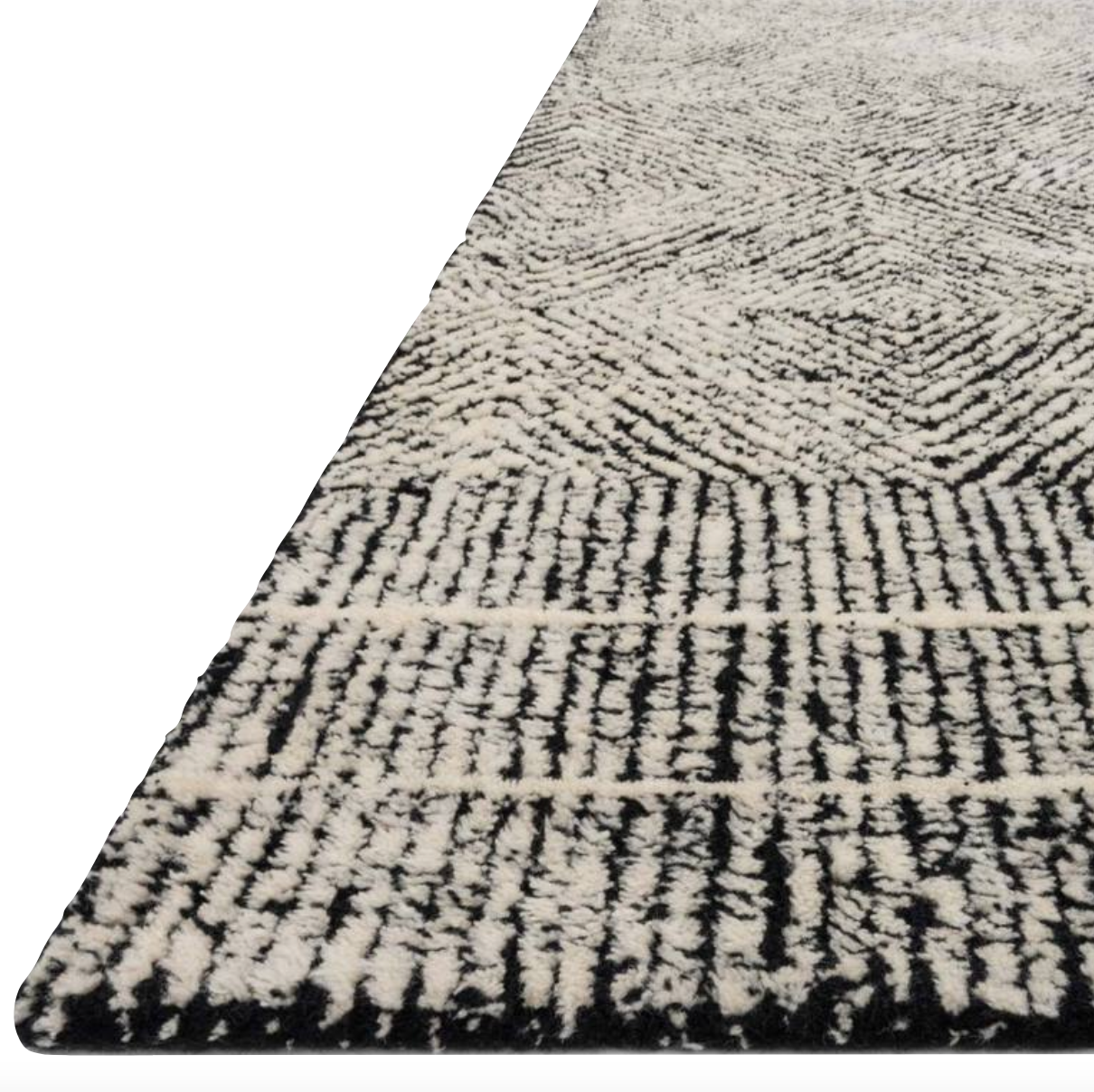 With stunning and delicate linear patterns, the Kopa Collection provides an energetic and fresh canvas for a low profile, long-lasting 100% wool rug. Each design is hand-tufted by skilled artisans in India. Crafted by Loloi for ED Ellen DeGeneres.  Hand Tufted 100% Wool India KO-01 ED Black/Ivory