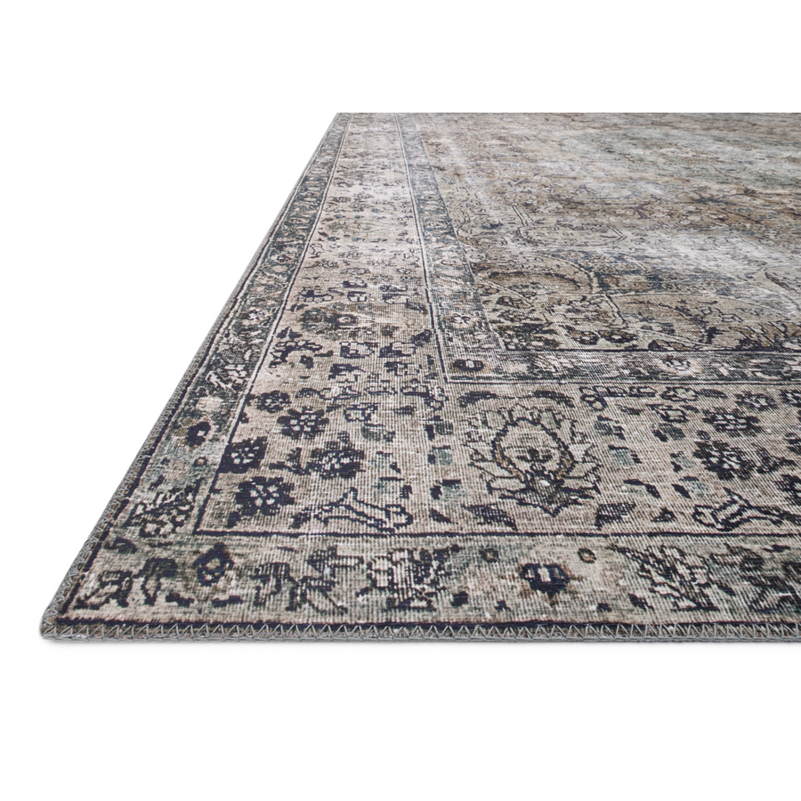 The Layla Collection is traditional and timeless, with a beautiful lived-in design that captures the spirit of an old-world rug. This traditional power-loomed rug is crafted of 100% polyester with a classic and sophisticated color palette and subtle patina.  Power Loomed 100% Polyester LAY-06 Taupe/Stone