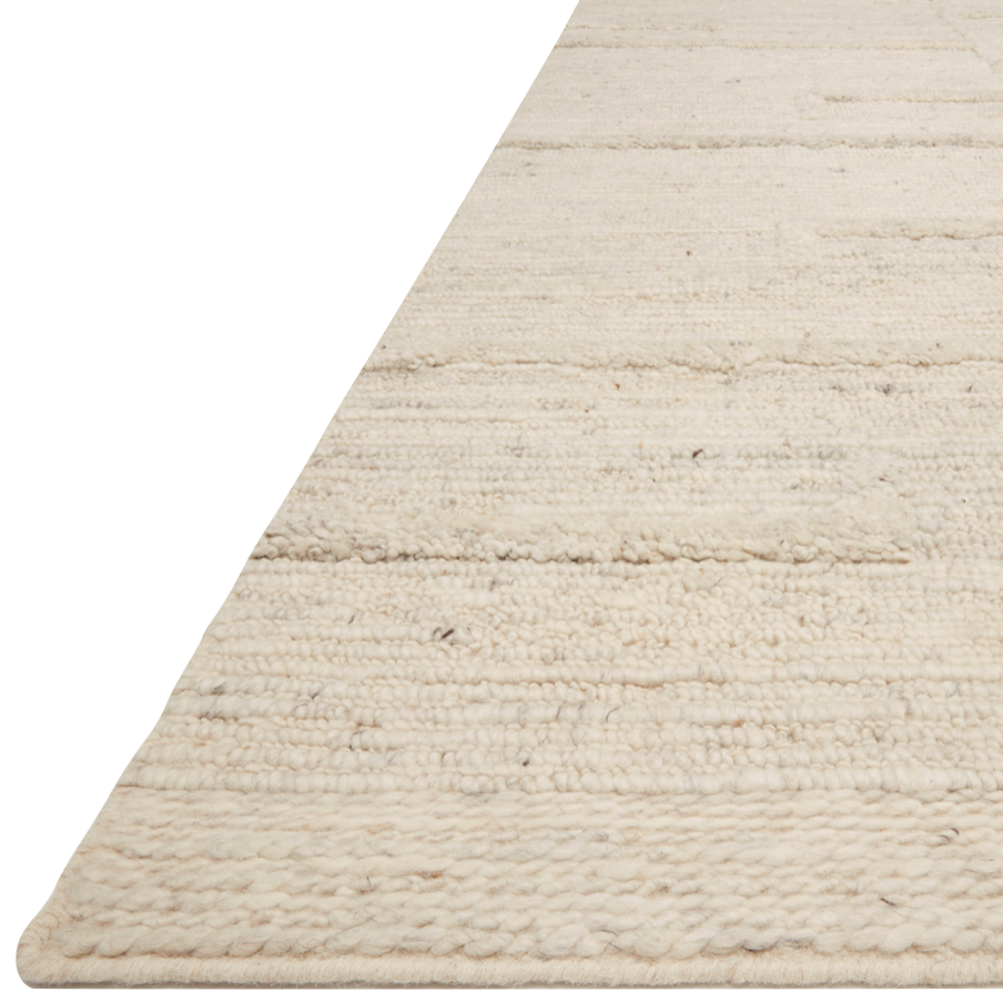 Hand-woven of 100% wool in India, the Loloi Rayan Ivory Area Rug, or RAY-01, sets the tone for a calming atmosphere. Each design is crafted of textural highs and lows paired with neutral tones to create and engaging understatement. The perfect rug for your bedroom, office, or other medium traffic area. 