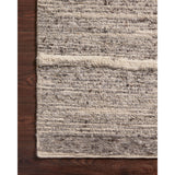 Hand-woven of 100% wool in India, the Loloi Rayan Charcoal / Ivory Area Rug, or RAY-03, sets the tone for a calming atmosphere. Each design is crafted of textural highs and lows paired with neutral tones to create and engaging understatement. The perfect rug for your bedroom, office, or other medium traffic area. 