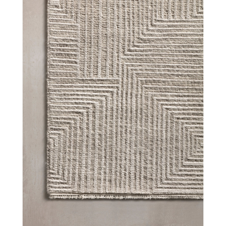 Intricately hand-knotted in India of wool and viscose pile, the Loloi Rhea Taupe Area Rug, or REH-01, is beautifully delicate with an oblique striping of a lace-like quality and a pearly, neutral color palette. The hi-lo pattern adds a sophisticated yet striking appeal to any living room or other high traffic area. 