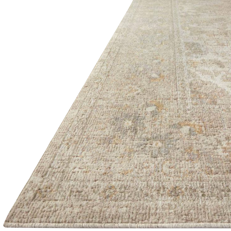Durable, low pile, and soft, this rug is inspired by classic vintage and antique rugs. The Rosemarie Chris Loves Julia Ivory / Natural ROE-02 rug from Loloi features a beautiful vintage pattern and patina. The rug is easy to clean, never sheds, and perfect for living rooms, dining rooms, hallways, and kitchens!