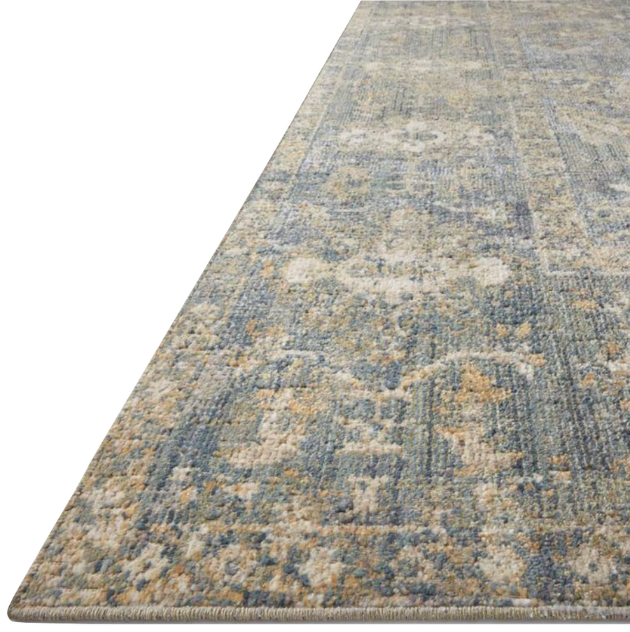 Durable, low pile, and soft, this rug is inspired by classic vintage and antique rugs. The Rosemarie Chris Loves Julia Sand / Lagoon ROE-03 rug from Loloi features a beautiful vintage pattern and patina. The rug is easy to clean, never sheds, and perfect for living rooms, dining rooms, hallways, and kitchens!