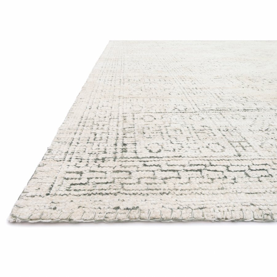 Hand-knotted in India of viscose and cotton, the Vestige White / Stone Area Rug recalls ancient khotan rugs in an updated color palette. Soft underfoot, the silken yarns temper the graphic motifs to create a versatile foundation.  Hand Knotted 91% Viscose | 9% Cotton VQ-01 White / Stone