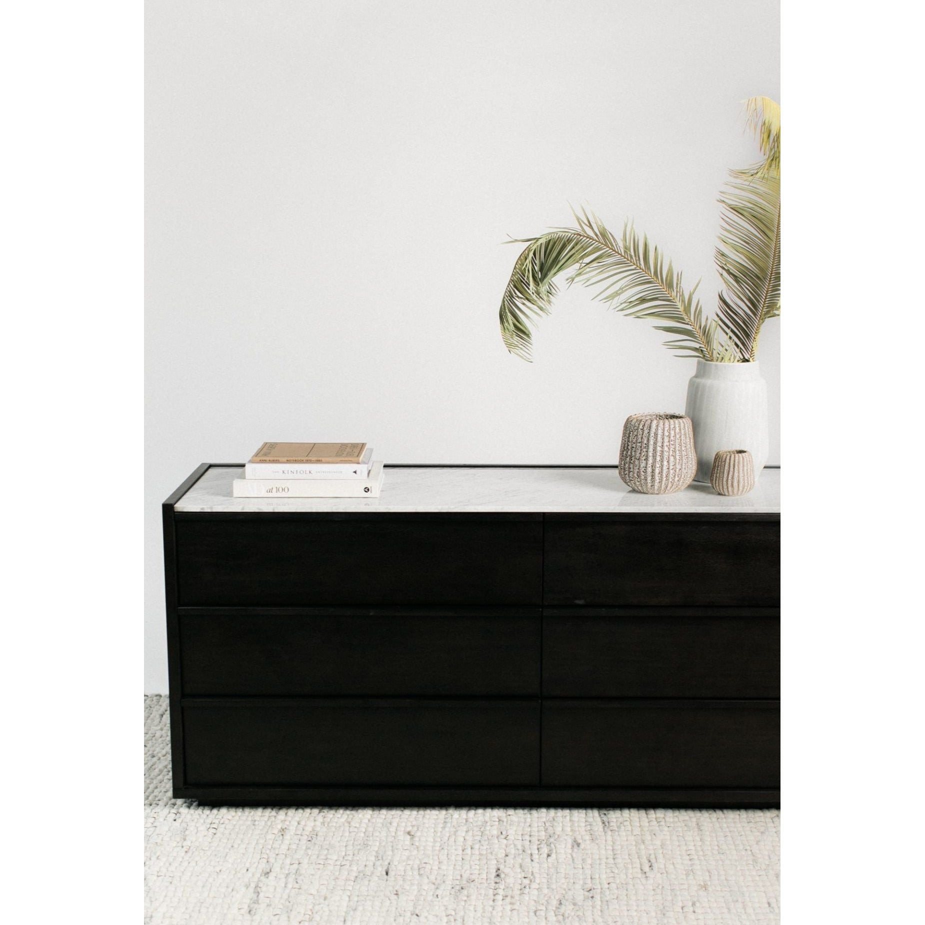 We love the mix of light and dark found with this Ashcroft Dresser. A block of darker acacia wood is set against a natural white marble slab featuring a 6-drawer count, perfect for any bedroom!  Size: 68.5"W x 19"D x 30"H