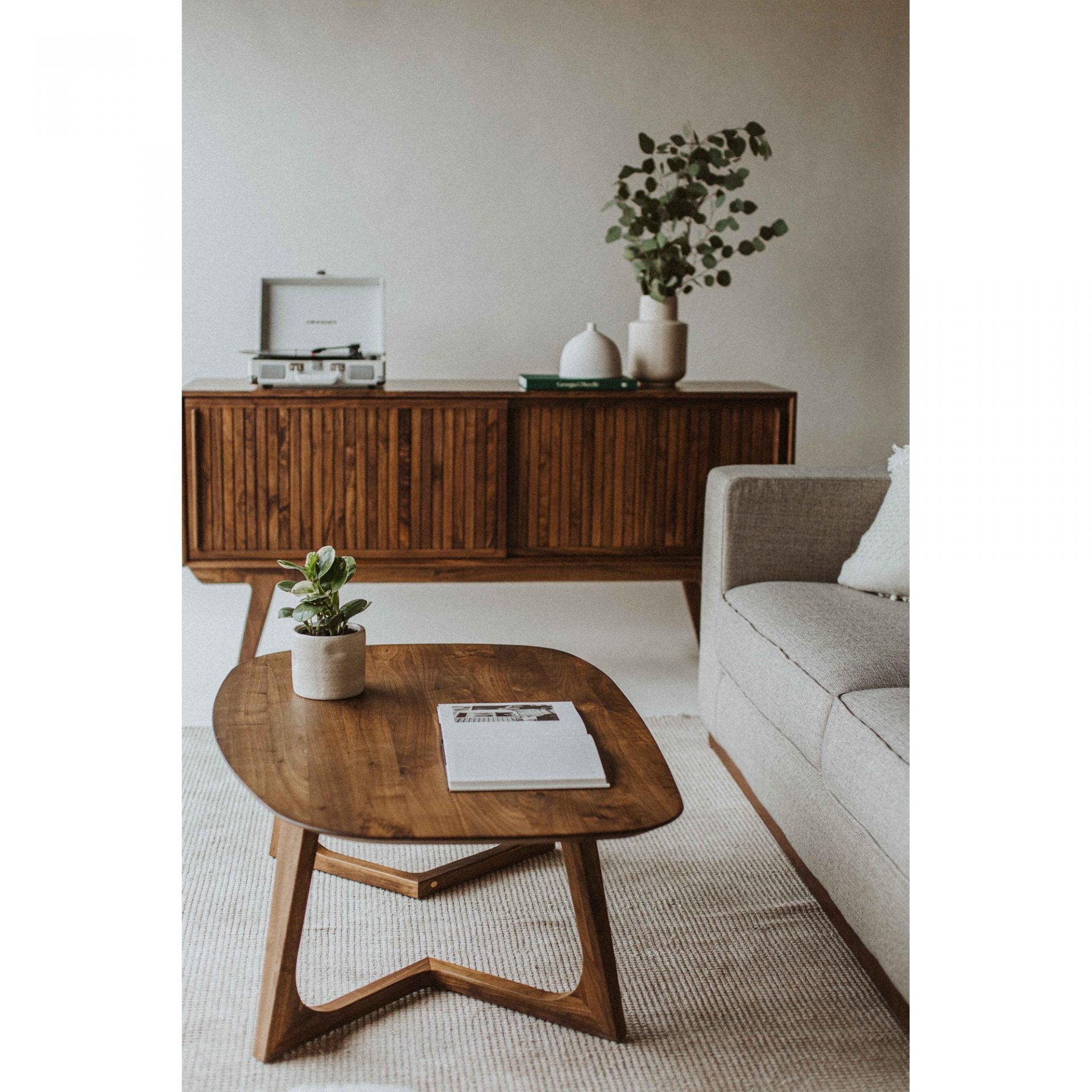 With a solid walnut finish and unique shape, this Godenza Coffee Table is a contemporary take on a mid-century modern classic. Made from solid, high-quality American walnut, this coffee table's warm hues brighten up your space while offering a medium-sized tabletop for your everyday needs.  Size: 42"W x 27.5"D x 15"H