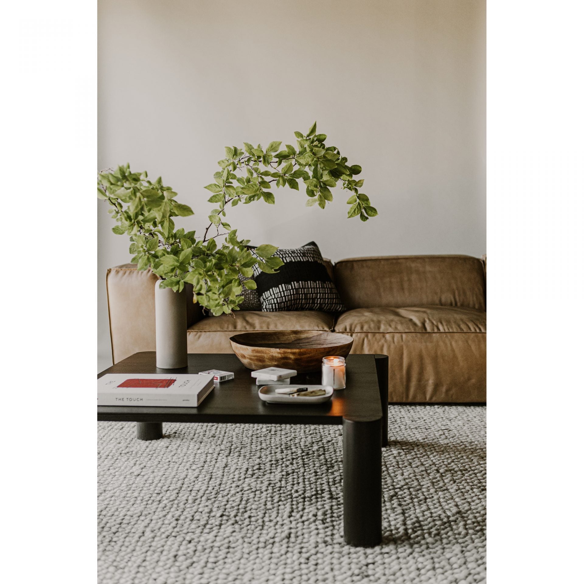 We love the unique legs found on this Post Coffee Table - Black Oak. Made from solid oak, this coffee table sits lower to the ground, inviting more communication on its sturdy dowel legs.  Dimensions: 36"W x 36"D x 13"H Materials:  Solid Oak