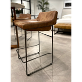 Upgrade your kitchen or dining room with this sleek, cocktail-ready Starlet Counter + Bar Stool - Open Road Brown Leather that showcases poise and comfort. This adds a cool sophistication to your space with its slim iron frame and luxe leather upholstery. 
