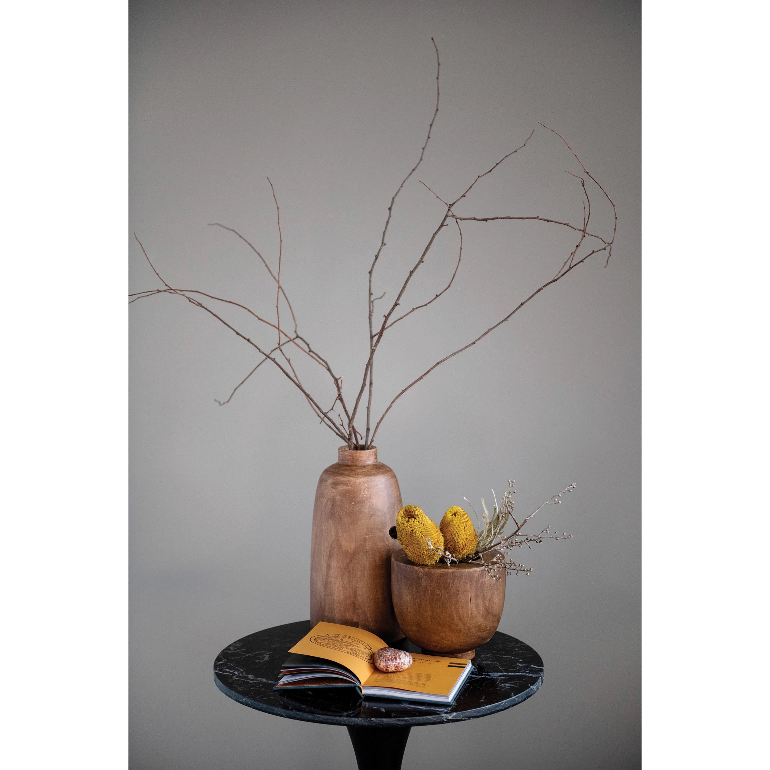 This Paulownia Walnut Vase is a beautiful way to display faux or real florals. Made out of paulownia wood, this vase has a simple brown coloring  Size: 7.75" Round x 14.25"H