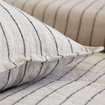 The Blake Duvet Collection Flax/Midnight by Pom Pom at Home features an interwoven stripe texture, giving a modern refresh to a traditional stripe. Our duvet and shams are hand-loomed by artisans and the linen is washed for a relaxed lived-in look for any bedroom.   Inserts sold separately 100% linen Shell-button closure Machine wash cold; tumble dry low; warm iron as needed. Do not bleach