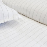 The Blake Duvet Collection White/Ocean by Pom Pom at Home features an interwoven stripe texture, giving a modern refresh to a traditional stripe. Our duvet and shams are hand-loomed by artisans and the linen is washed for a relaxed lived-in look for any bedroom.    Inserts sold separately 100% linen Shell-button closure Machine wash cold; tumble dry low; warm iron as needed. Do not bleach