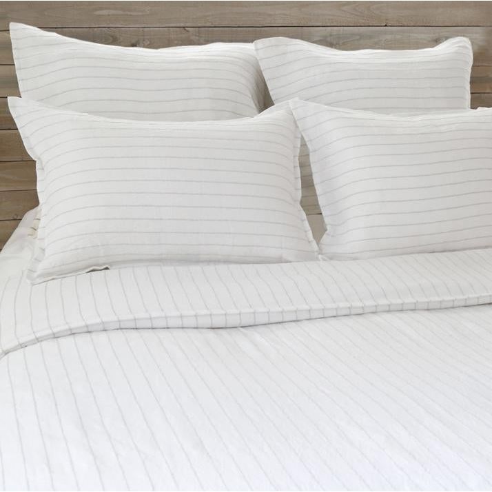 The Blake Duvet Collection White/Ocean by Pom Pom at Home features an interwoven stripe texture, giving a modern refresh to a traditional stripe. Our duvet and shams are hand-loomed by artisans and the linen is washed for a relaxed lived-in look for any bedroom.    Inserts sold separately 100% linen Shell-button closure Machine wash cold; tumble dry low; warm iron as needed. Do not bleach