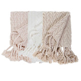 This Capistrano Throw - Three Colors is a soft cable knit throw featuring Pom Pom at Home's popular long twisted tassels along the edge. Available in 3 gentle colors.   Size: 50" x 70" Material: 100% Acrylic