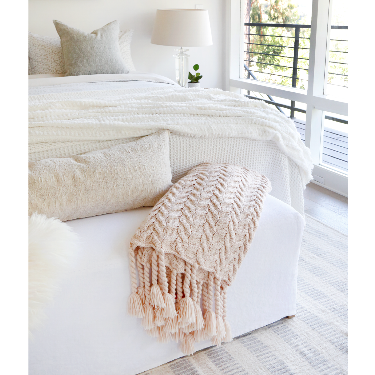 This Capistrano Throw - Three Colors is a soft cable knit throw featuring Pom Pom at Home's popular long twisted tassels along the edge. Available in 3 gentle colors.   Size: 50" x 70" Material: 100% Acrylic
