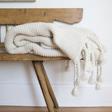 Indulge in this oversized cable-knit throw complemented with a tassel design. This Trestles Overside Throw - Three Colors by Pom Pom at Home is the perfect throw to wrap yourself with or dress at the foot of the bed.