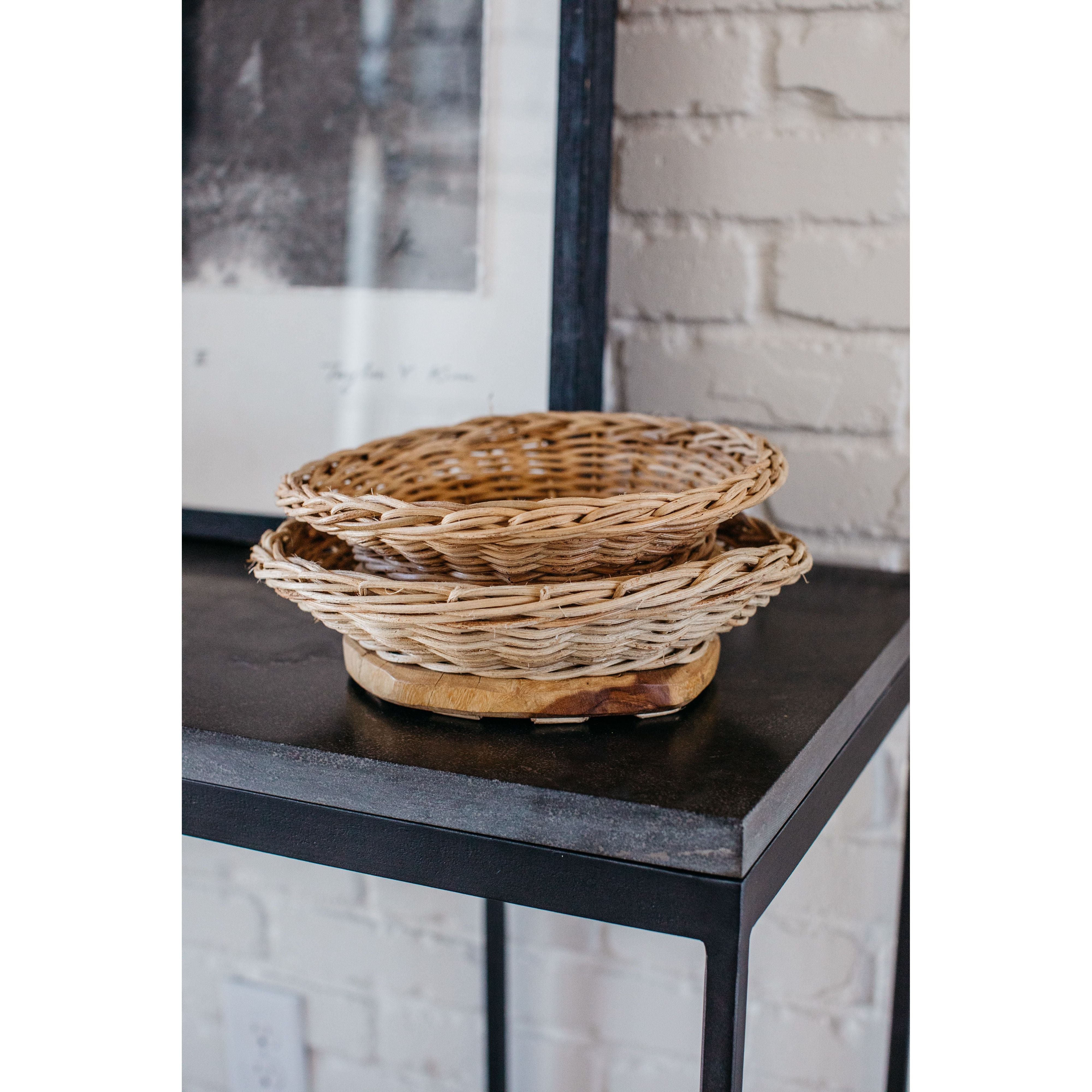 We love the organic look of this hand-woven Rattan & Mango Wood Live Edge Bowl. Showcase your favorite accessories or place your dried flowers to complete the look.   Small: 11"L x 10"W  Medium: 13"L x 9.5"W