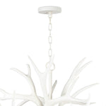 The resin Antler Chandelier wears a modern, matte white finish. Hang in a living room, kitchen, dining area or office to create a modern-lodge feel.  Dimensions: 21.5"h x 33"w x 33"d