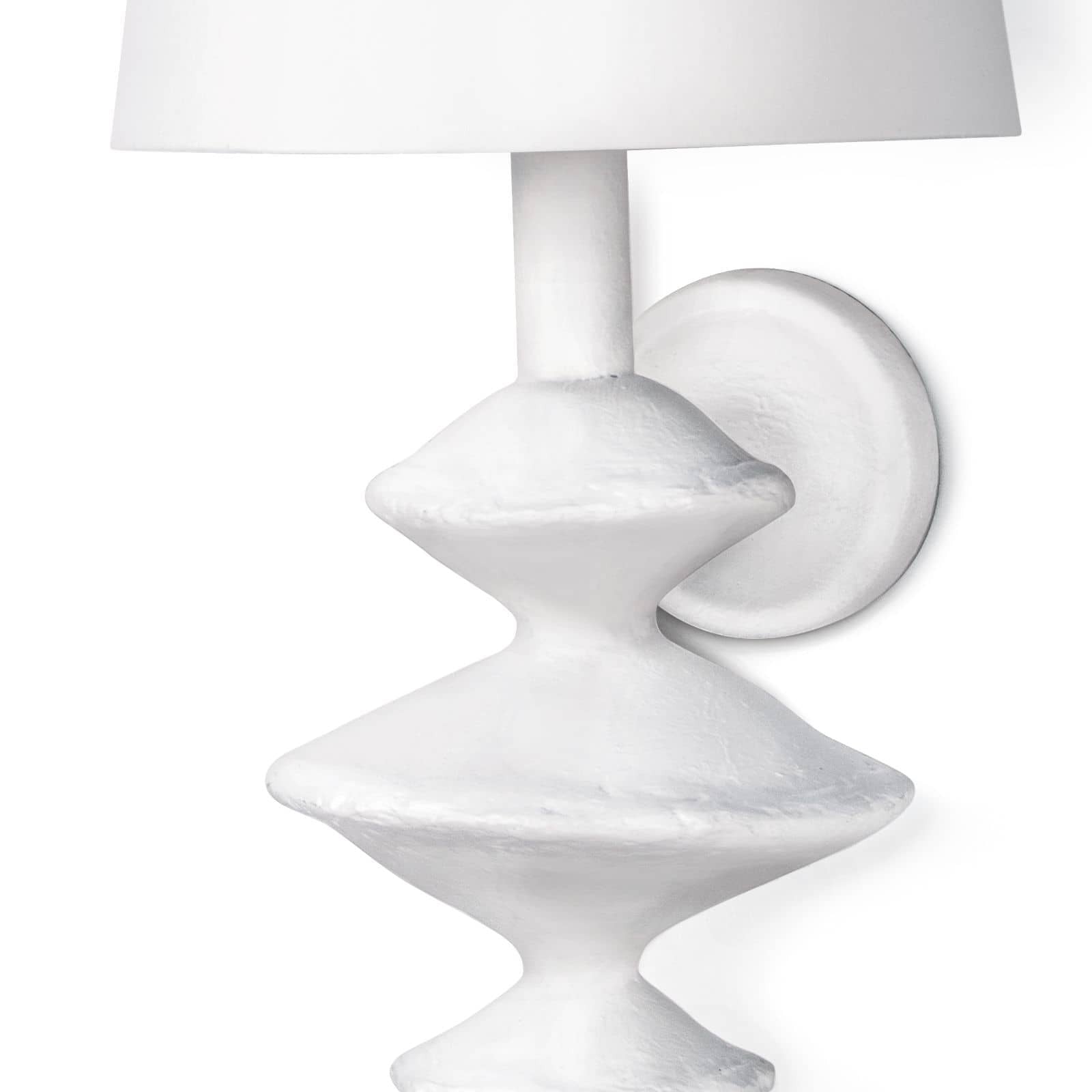 The curves on this Hope Sconce with the matte white finish give this sconce a textured look. This is inspired by a paper mache sculpture and would look amazing lined down a hallway, in your living room, or other space in your home needing extra light.  Overall size: 10"w x 10"d x 21"h