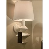 The curves on this Hope Sconce with the matte white finish give this sconce a textured look. This is inspired by a paper mache sculpture and would look amazing lined down a hallway, in your living room, or other space in your home needing extra light.  Overall size: 10"w x 10"d x 21"h