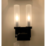 This bold Montecito Outdoor Sconce Double showcases the architecturally inspired lines of Montecito, California's Spanish Colonial estates. The charcoal frame and frosted glass light cover provide a beautiful diffused glow -- the perfect addition to your outdoor lighting-scape or inside area.  Dimensions: 12.75"h x 6.25"w x 4"d