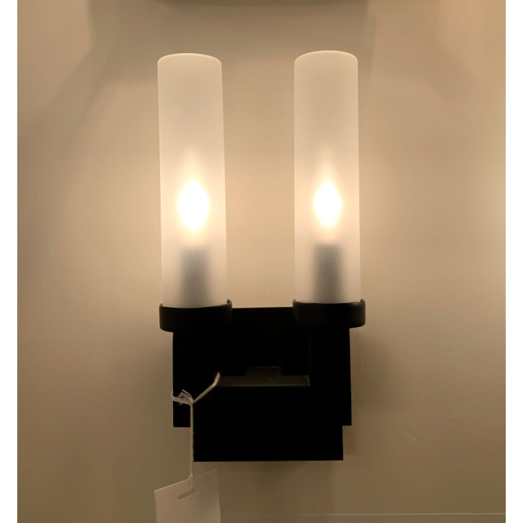 This bold Montecito Outdoor Sconce Double showcases the architecturally inspired lines of Montecito, California's Spanish Colonial estates. The charcoal frame and frosted glass light cover provide a beautiful diffused glow -- the perfect addition to your outdoor lighting-scape or inside area.  Dimensions: 12.75"h x 6.25"w x 4"d