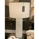 We love the accordion-like base of this Nabu Metal Column Table Lamp. It is a simple and beautiful lamp that adds warmth to any room.  Size: 17"w x 17"d x 30"h Material: Aluminum