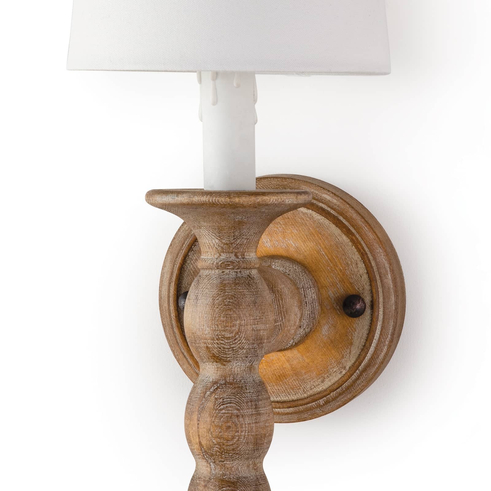This Perennial Sconce - Natural is hand lathed from solid wood and distressed for a rustic chic effect. The added faux drip wax details on the candle sleeves add to the charm and relaxed coastal style to any living room, bedroom, or other space.   Overall Dimensions: 6"w x 7"d x 19"h