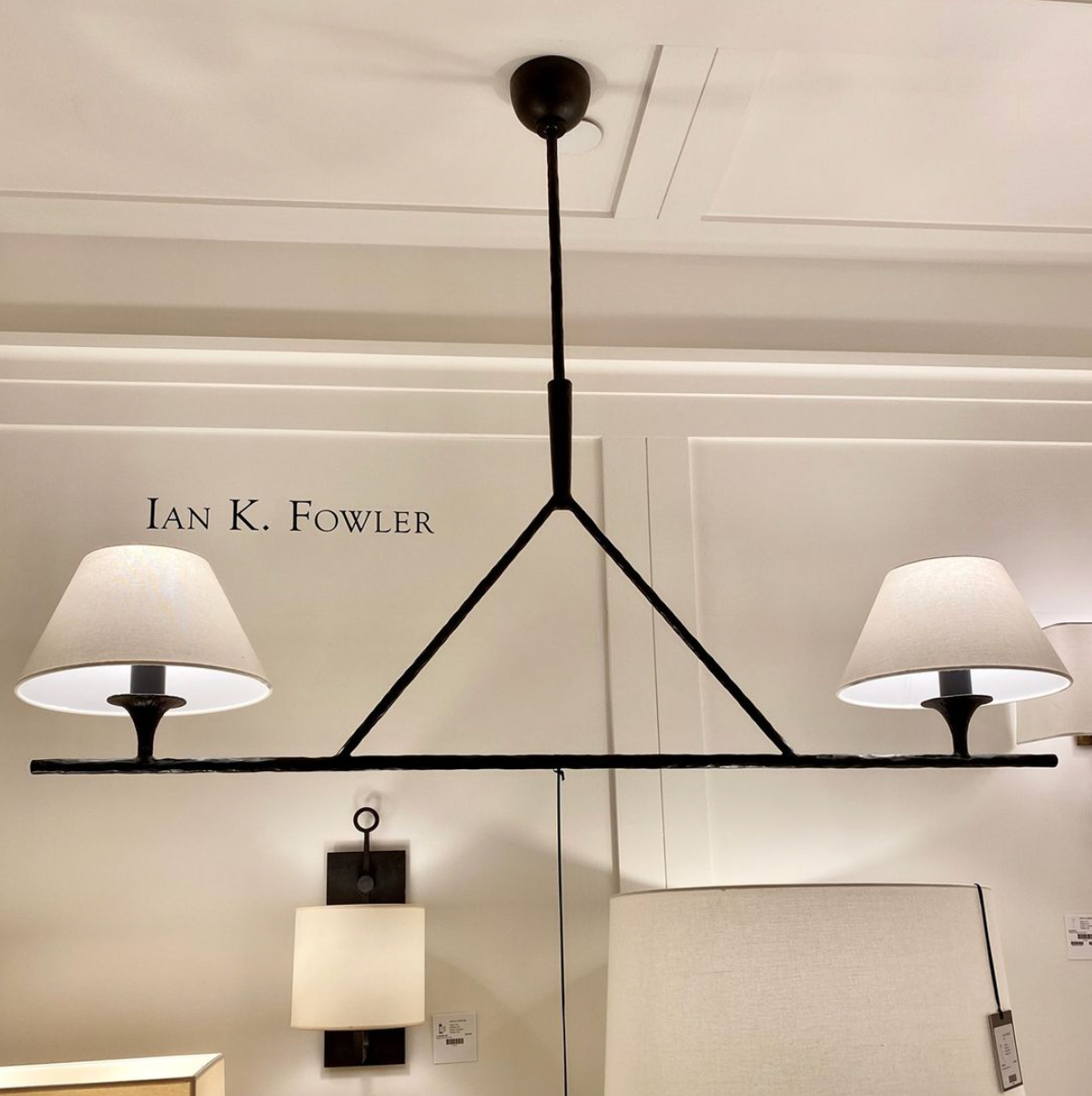 The Cesta Linear Chandelier by Visual Comfort is finished in aged iron with a linen shade. We love the timeless look it brings to a living room, dining room, or other large area.   Designer: Ian K. Fowler  O/A Height: 57.5" Min. Custom Height: 29.5" Width: 54" x 12" Canopy: 4.75" Round Socket: 2 - E26 Keyless Wattage: 2 - 60 A Weight: 24 lbs 