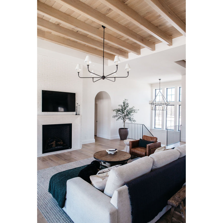 This Piaf Grande Chandelier from Visual Comfort has linen shades and brings a warm, classic look to any entry way, living room, or other large area.   Designer: Thomas O'Brien  Overall Height: 56.75" Min. Custom Height: 22.75" Width: 58" Canopy: 4.75" Round Socket: 6, E12 Candelabra Wattage: 6, 40 B Weight: 40 lbs
